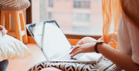 Image of woman working at a laptop