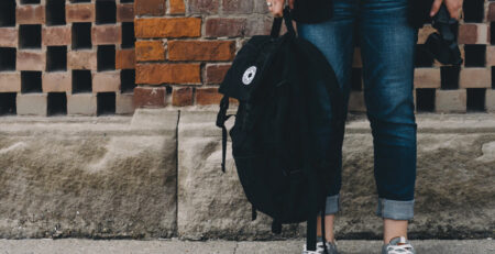 Photo of person holding a large backpack