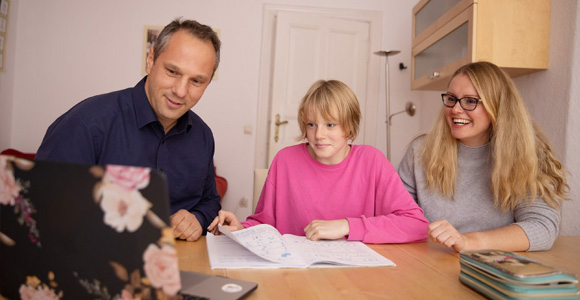 Photos of two parents and their school-aged child working together at a desk with papers and a laptop on the surface