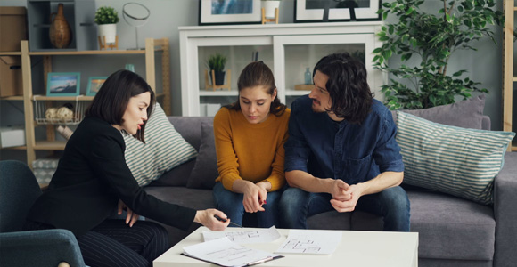 Photo of two people reviewing documents with an advisor